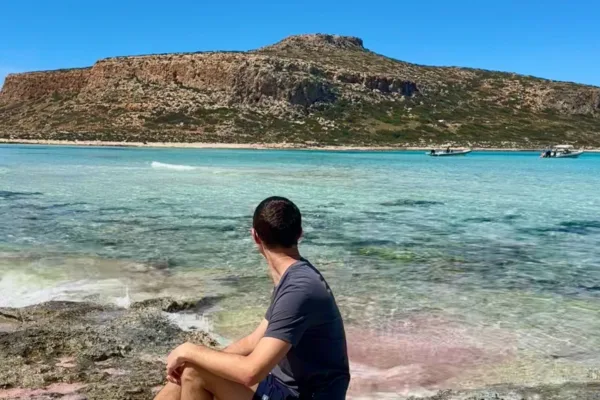 pink sand with crystal blue water at balos beach and lagoon is one of the best things to do in Crete Greece