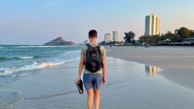 digital nomad walking on Hua Hin Beach in thailand