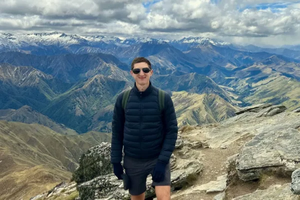 Hiker on mountain summit, scenic view of Ben Lomond Hike track near queenstown