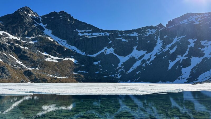 views of snow capped mountains under a glacial lake at Lake Atla near Queenstown New Zealand