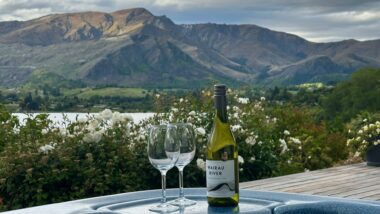 Wine and glasses with mountain view from hot tub at Lake Hayes Accommodation near Queenstown