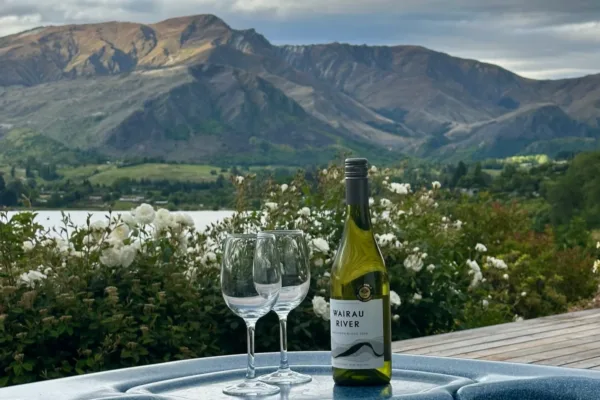 Wine and glasses with mountain view from hot tub at Lake Hayes Accommodation near Queenstown