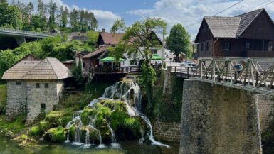 views of waterfalls falling over stones underneath town Rastoke Slunj Croatia