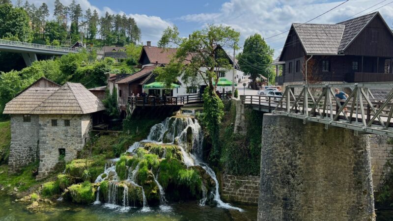 views of waterfalls falling over stones underneath town Rastoke Slunj Croatia