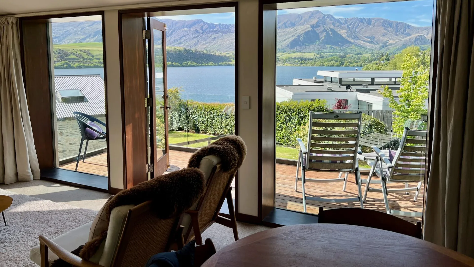 views of Lake Hayes and snow capped mountains from luxury apartment, in one of the best places for where to stay in queenstown