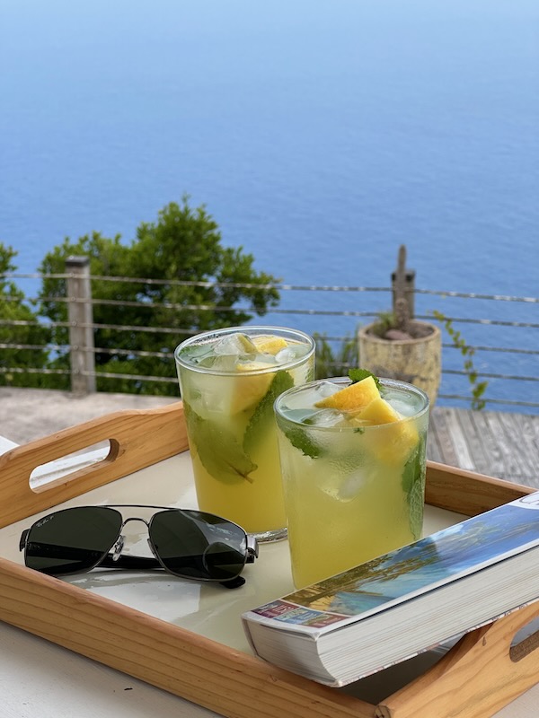 cocktails and book on balcony overlooking beautiful Caribbean Sea