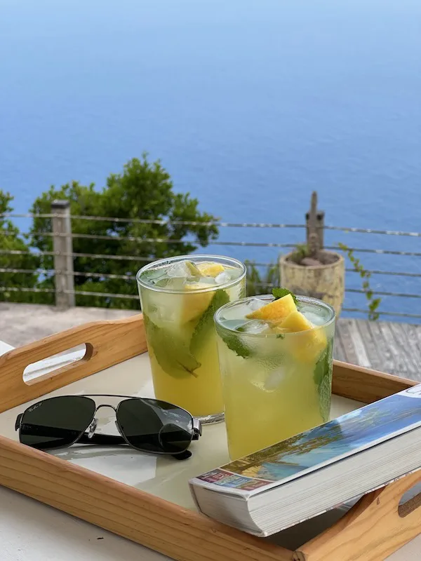 cocktails and book on balcony overlooking beautiful Caribbean Sea