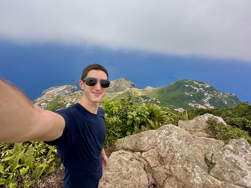 travel blogger man standing on top of mount scenery peak in Saba Caribbean Netherlands