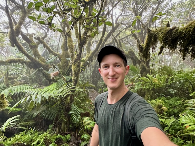 a man taking a selfie in a forest