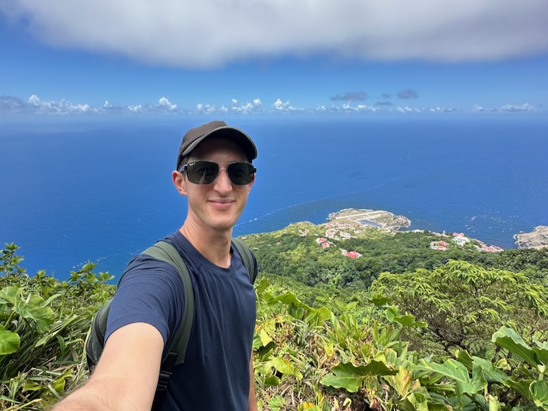 man standing overlooking Sandy Cruz Trail in Saba