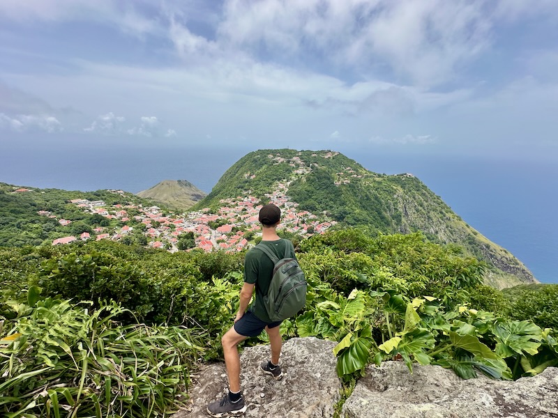 travel blogger on rocks overlooking Windwardside in Saba