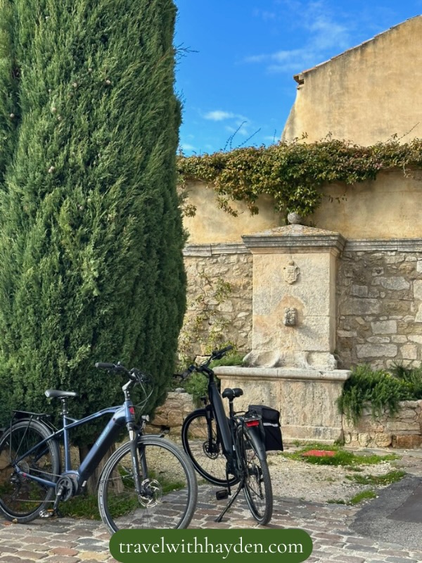 Bicycles near a stone fountain in Provence town