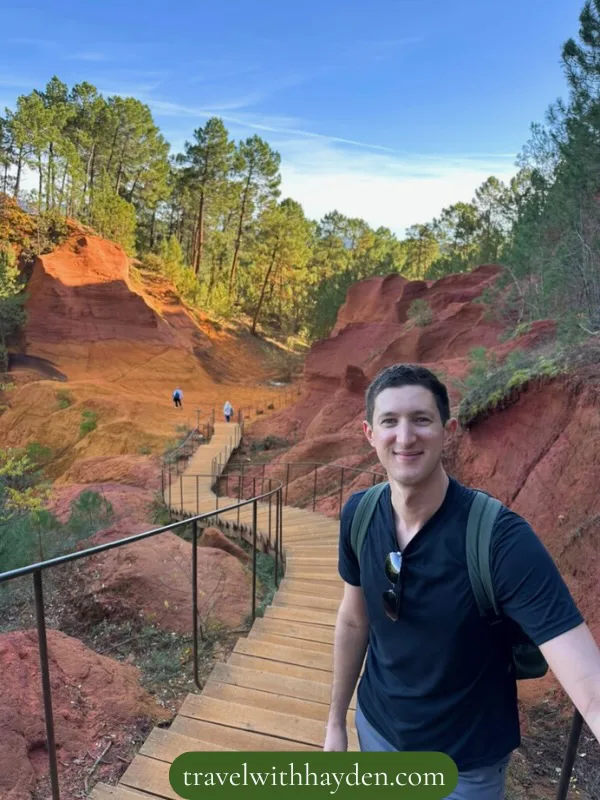 Red rock formations with wooden pathway in Rousillon Provence travel tips