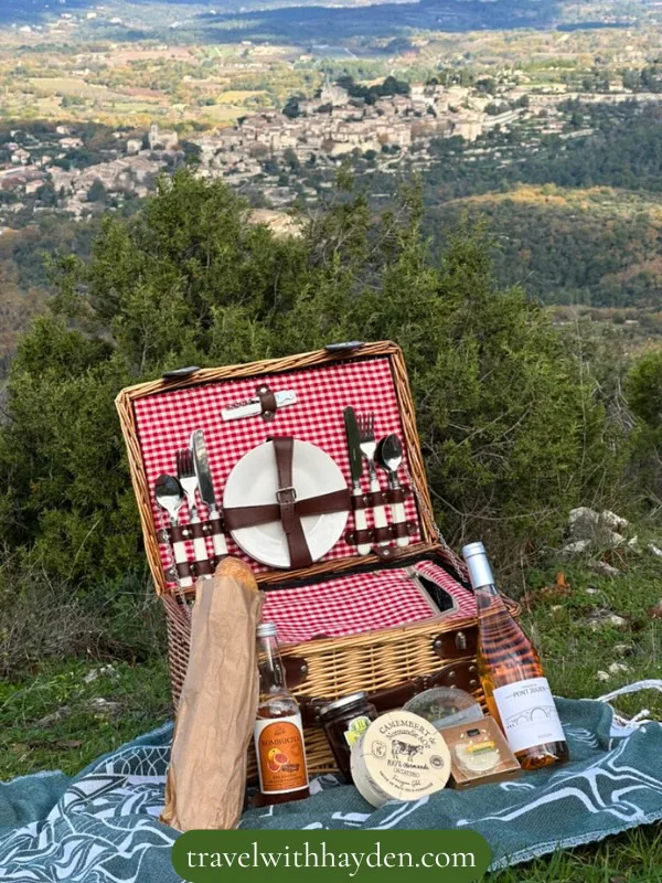 Picnic basket with scenic view in Luberon Valley in Provence
