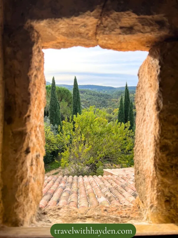 Scenic view through a stone window in traditional Provencal cottage