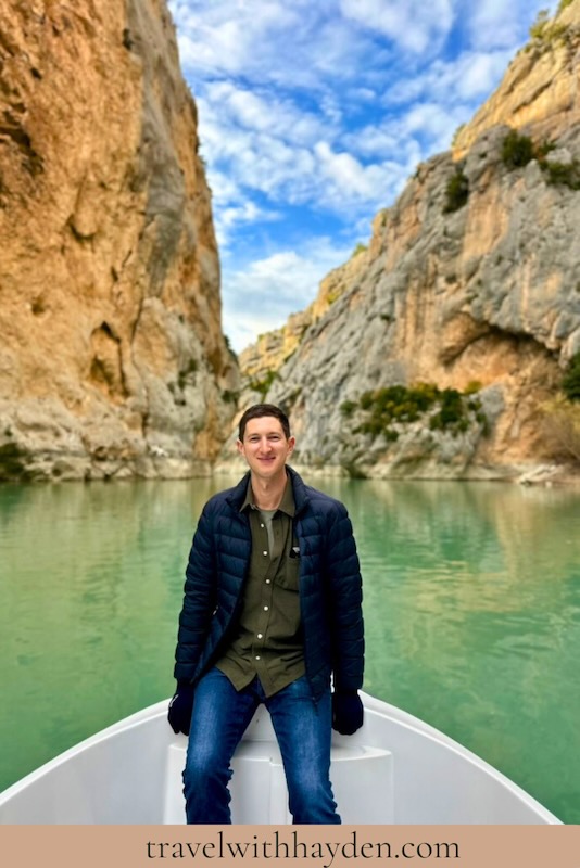 Person sitting in scenic canyon boat.