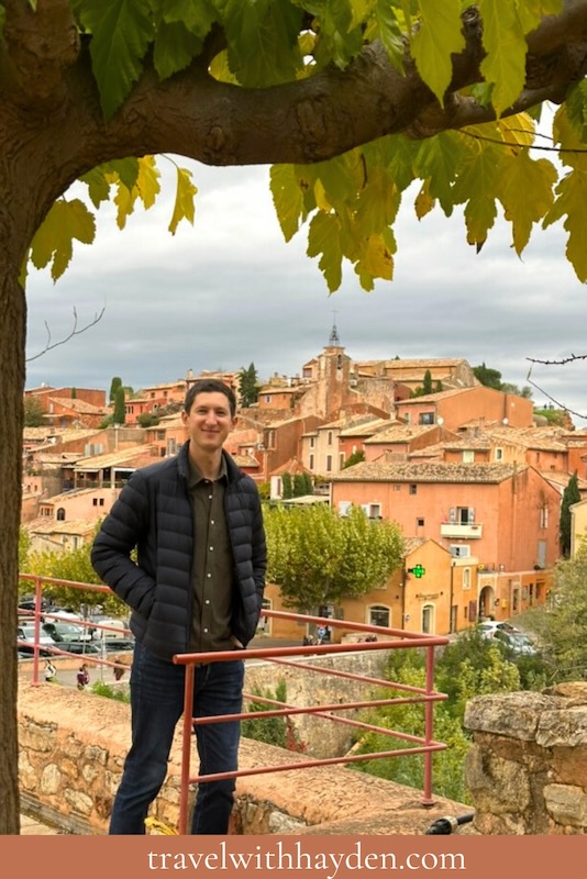 man standing overlooking Roussillon provence from a viewpoint in French countryside