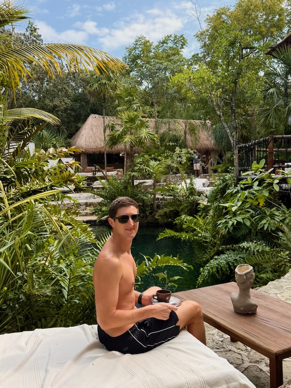 Man relaxing in tropical garden setting.