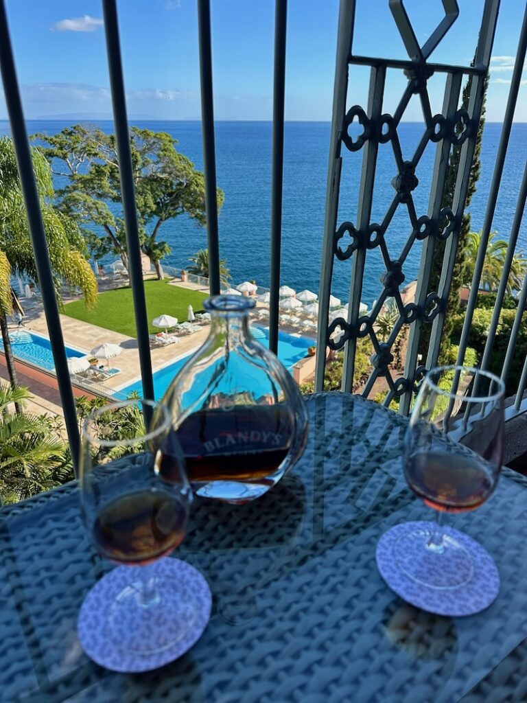 madeira wine on balcony overlooking pool and ocean at Reid's Palace Madeira