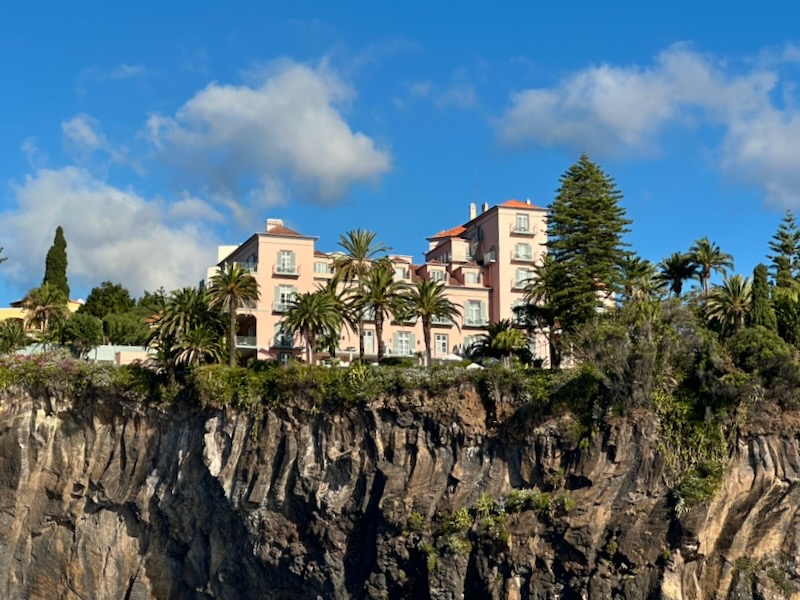 cliffside views from water of Reid's Palace Madeira